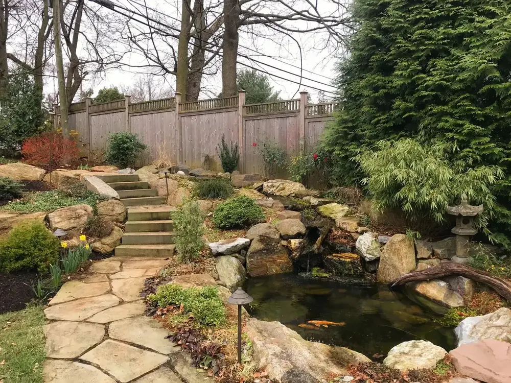 The view off a flagstone patio in the spring on a neighbors property.